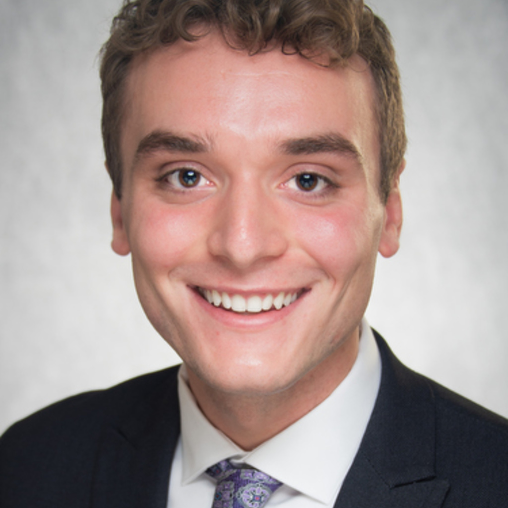 man with short brown hair in a suit