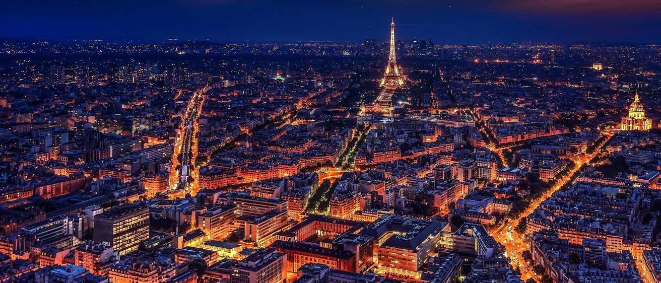 The nighttime lights of the Eiffel Tower and surrounding area of Paris, France.